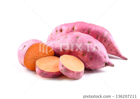 Sweet potato with cut slices on white surface 136207211