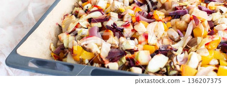 Fresh vegetables are chopped and placed on a baking tray ready for cooking in the oven. Colorful ingredients are showcased, and the setting is a welcoming kitchen, banner Fresh vegetables are chopped and placed on a baking tray ready for cooking in the oven. Colorful ingredients are showcased, and the setting is a welcoming kitchen, banner 136207375