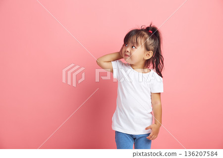 Curious little girl keeps hand near ear for eavesdropping likes gossip, wants to overhear secret information, tries to hear parents conversation. Curious little girl keeps hand near ear for eavesdropping likes gossip, wants to overhear secret information, tries to hear parents conversation. 136207584