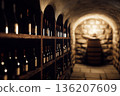 Stone wine cellar with bottle racks and barrel 136207609
