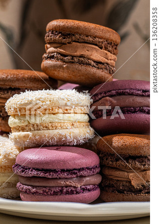 Assorted macarons stacked on decorative plate Assorted macarons stacked on decorative plate 136208358