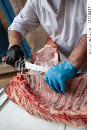 Meat processing by the butcher 136208374