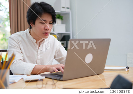 Startup professional working on business project and studying online marketing strategy Startup professional working on business project and studying online marketing strategy 136208578