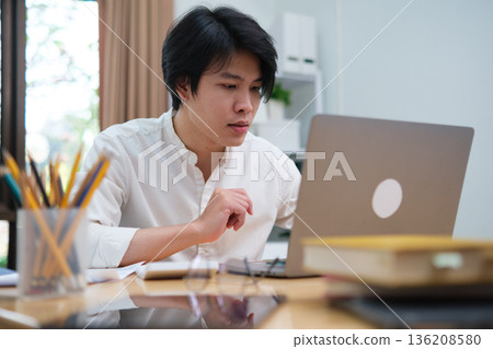 Startup professional working on business project and studying online marketing strategy Startup professional working on business project and studying online marketing strategy 136208580
