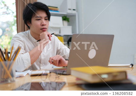 Startup professional working on business project and studying online marketing strategy Startup professional working on business project and studying online marketing strategy 136208582