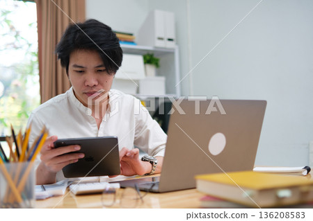 University student studying online or startup entrepreneur managing digital business online. University student studying online or startup entrepreneur managing digital business online. 136208583