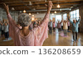 Joyful yoga session uniting seniors and young adults in a serene studio 136208659