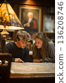 Students explore old maps in a cozy library corner during a quiet afternoon 136208746