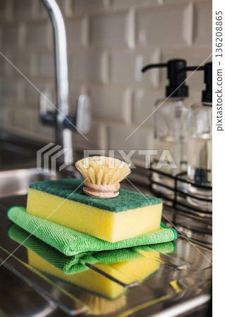 Wooden brush for washing dishes in the kitchen next to sink. Eco friendly, zero waste or conscious consumption concept. Copy space Wooden brush for washing dishes in the kitchen next to sink. Eco friendly, zero waste or conscious consumption concept. Copy space 136208865