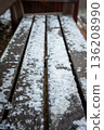 Icy park bench in winter 136208990