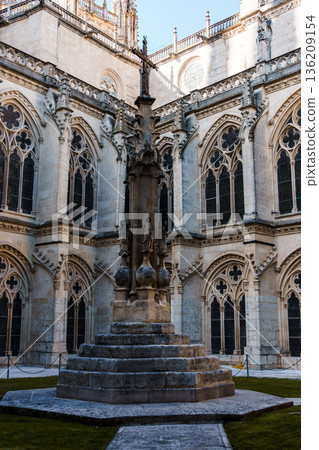 Burgos Cathedral cloister with ornate stonework and stained glass windows Burgos Cathedral cloister with ornate stonework and stained glass windows 136209154