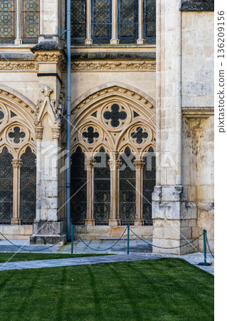 Burgos Cathedral cloister with ornate stonework and stained glass windows Burgos Cathedral cloister with ornate stonework and stained glass windows 136209156