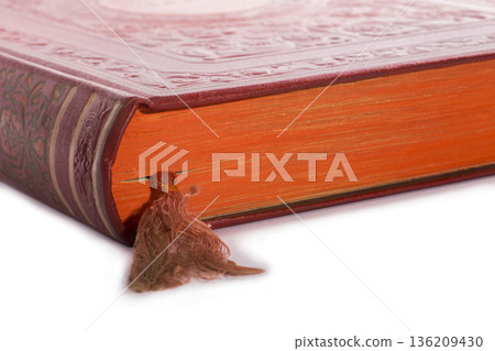 A bookmark in a large red book A bookmark in a large red book 136209430