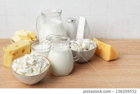 Assortment of fresh dairy products on wooden table 136209552