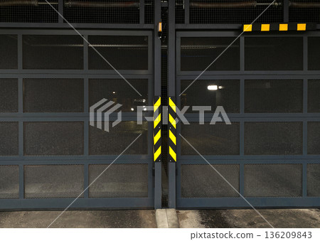 Industrial garage doors with mesh panels and caution stripes, showcasing modern design and functionality, creating a secure environment for vehicles and equipment storage Industrial garage doors with mesh panels and caution stripes, showcasing modern design and functionality, creating a secure environment for vehicles and equipment storage 136209843