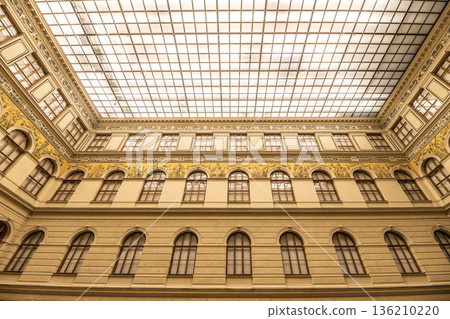 The ceiling of the National Museum in Prague shows intricate designs and bright lights. Visitors can see the artfully arranged glass and structure above while exploring the museum. The ceiling of the National Museum in Prague shows intricate designs and bright lights. Visitors can see the artfully arranged glass and structure above while exploring the museum. 136210220