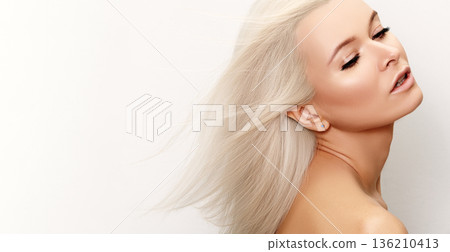 Graceful Woman With Flowing Hair. Serene Blonde Woman Radiating Calm, Effortless Charm In Motion. Caucasian Woman With Windblown Hair And Glowing Skin Exudes Peaceful Elegance And Grace. Blond Beauty 136210413