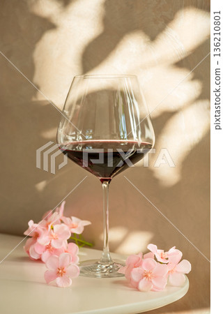 Red Wine Glasses with Sakura Cherry Blossoms. Elegant Spring Still Life Red Wine Glasses with Sakura Cherry Blossoms. Elegant Spring Still Life 136210801