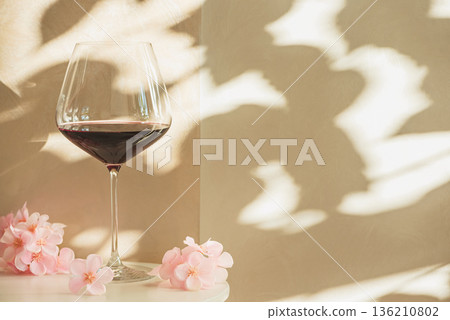 Red Wine Glasses with Sakura Cherry Blossoms. Elegant Spring Still Life Red Wine Glasses with Sakura Cherry Blossoms. Elegant Spring Still Life 136210802