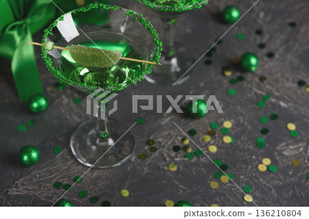 Green Cocktails with Lime, Gifts and Confetti. Festive St. Patricks Day Celebration Still Life Green Cocktails with Lime, Gifts and Confetti. Festive St. Patricks Day Celebration Still Life 136210804