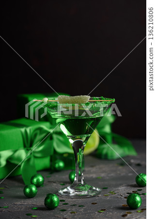 Green Cocktails with Lime, Gifts and Confetti. Festive St. Patricks Day Celebration Still Life Green Cocktails with Lime, Gifts and Confetti. Festive St. Patricks Day Celebration Still Life 136210806