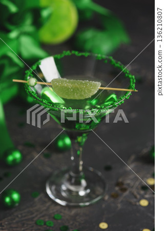 Green Cocktails with Lime, Gifts and Confetti. Festive St. Patricks Day Celebration Still Life Green Cocktails with Lime, Gifts and Confetti. Festive St. Patricks Day Celebration Still Life 136210807