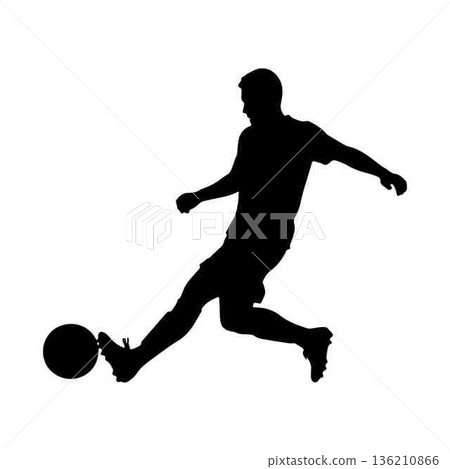 Silhouette of a soccer player kicking a ball with power 136210866