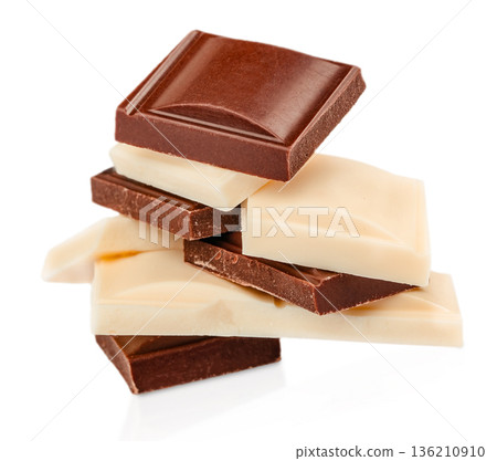 Stacked milk and white chocolate pieces isolated on white Stacked milk and white chocolate pieces isolated on white 136210910