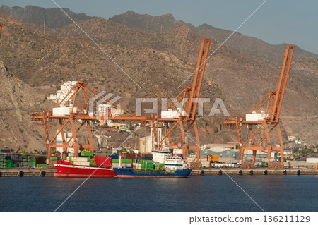 Cargo ship and container cranes at Santa Cruz de Tenerife port, Spain Cargo ship and container cranes at Santa Cruz de Tenerife port, Spain 136211129