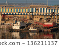 Floating crane barge and tugboats in industrial harbor 136211137