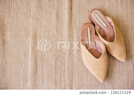 Stylish woven slip-on shoes in natural tones resting on a textured surface, showcasing modern design and comfort for casual or formal occasions with copy space Stylish woven slip-on shoes in natural tones resting on a textured surface, showcasing modern design and comfort for casual or formal occasions with copy space 136211329