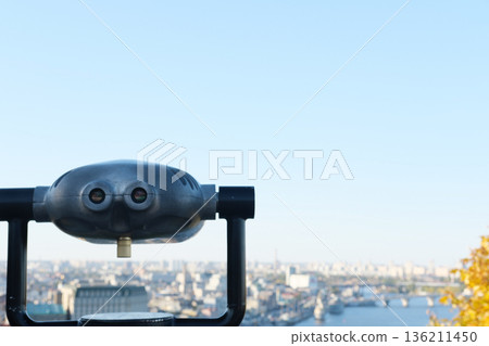 Observation deck with binoculars overlooking a vibrant cityscape, showcasing urban architecture, waterways, and distant skyline under clear blue sky, inviting exploration and discovery Observation deck with binoculars overlooking a vibrant cityscape, showcasing urban architecture, waterways, and distant skyline under clear blue sky, inviting exploration and discovery 136211450