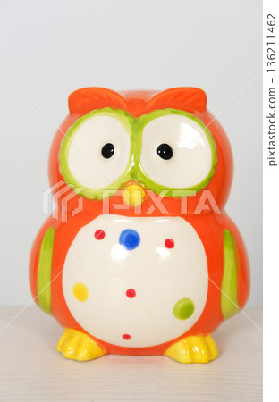Colorful ceramic owl figurine with large eyes and polka dots, showcasing vibrant orange and green hues, perfect for home decor or as a whimsical gift idea for children Colorful ceramic owl figurine with large eyes and polka dots, showcasing vibrant orange and green hues, perfect for home decor or as a whimsical gift idea for children 136211462