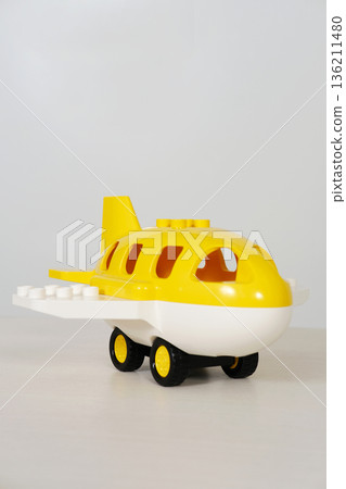 Bright yellow children's toy airplane with white body and black wheels, designed for imaginative play, perfect for young kids and toddlers, featuring playful design elements and vibrant colors Bright yellow children's toy airplane with white body and black wheels, designed for imaginative play, perfect for young kids and toddlers, featuring playful design elements and vibrant colors 136211480