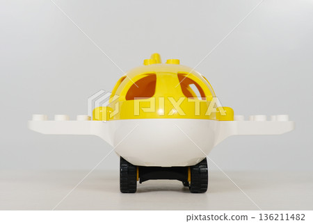 Bright yellow children's toy airplane on a white background, featuring playful design elements and smooth surfaces, ideal for imaginative play and creative storytelling Bright yellow children's toy airplane on a white background, featuring playful design elements and smooth surfaces, ideal for imaginative play and creative storytelling 136211482