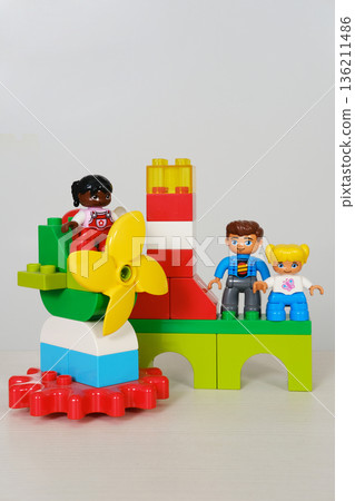 Colorful children's toy building set featuring playful figures and vibrant blocks, showcasing creativity and imagination with copy space for design purposes 136211486