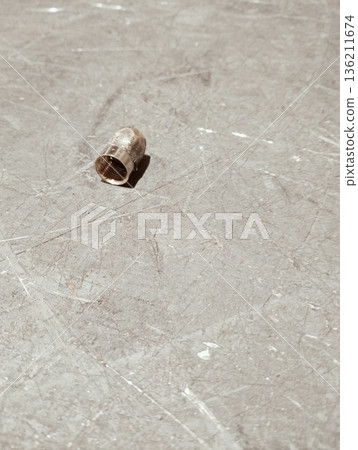 Broken metal compression ferrule with crack on industrial background 136211674