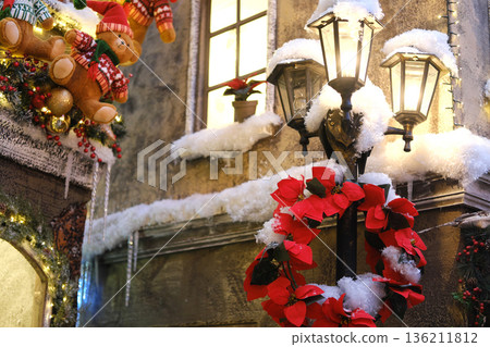 Beautifully decorated shopping center with festive garland, Christmas tree, and snow-covered lanterns, creating a stylish holiday atmosphere for joyful shopping experiences Beautifully decorated shopping center with festive garland, Christmas tree, and snow-covered lanterns, creating a stylish holiday atmosphere for joyful shopping experiences 136211812