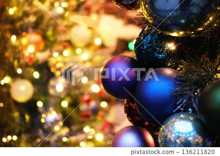 Colorful Christmas ornaments in various shades hang on a beautifully decorated tree, surrounded by twinkling lights and festive decorations, creating a joyful holiday atmosphere Colorful Christmas ornaments in various shades hang on a beautifully decorated tree, surrounded by twinkling lights and festive decorations, creating a joyful holiday atmosphere 136211820