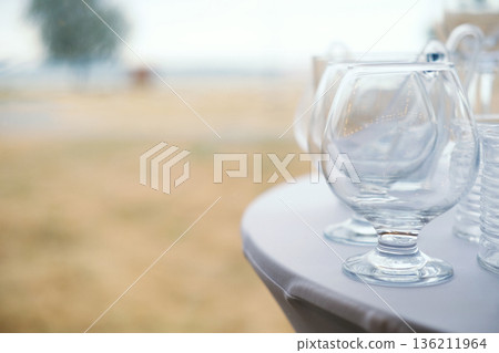 Elegant glassware arranged on a table, showcasing a refined setting for a wedding celebration, with soft focus background creating an inviting atmosphere with copy space Elegant glassware arranged on a table, showcasing a refined setting for a wedding celebration, with soft focus background creating an inviting atmosphere with copy space 136211964