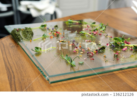 Leftover food remnants scattered on a glass plate, showcasing vibrant colors and textures, highlighting food waste disposal and the impact of culinary practices on sustainability Leftover food remnants scattered on a glass plate, showcasing vibrant colors and textures, highlighting food waste disposal and the impact of culinary practices on sustainability 136212126