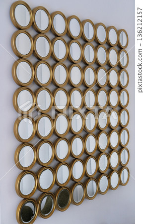 Decorative wall arrangement featuring multiple round mirrors in gold frames, creating a unique visual display that enhances interior aesthetics and reflects light beautifully Decorative wall arrangement featuring multiple round mirrors in gold frames, creating a unique visual display that enhances interior aesthetics and reflects light beautifully 136212157