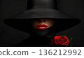 Elegant female model in retro hat with red lips and rose flower against a dark background 136212992