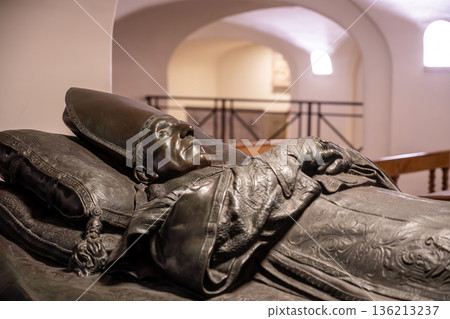 The tomb of Pope Benedict XV is located in the Vatican Grottoes. It is a bronze statue that depicts the pope in repose, resting on a bed. The site is a place of reflection and remembrance. The tomb of Pope Benedict XV is located in the Vatican Grottoes. It is a bronze statue that depicts the pope in repose, resting on a bed. The site is a place of reflection and remembrance. 136213237
