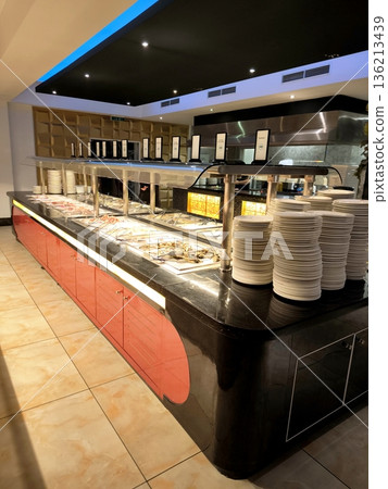 Self-service restaurant area with heated dishes and stacked plates Self-service restaurant area with heated dishes and stacked plates 136213439
