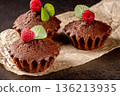 Mouth-watering muffins with raspberries on a chic black kitchen table surface 136213935