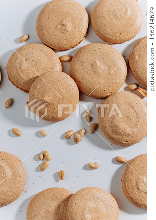 Peanut macarons flat lay on white background, minimal dessert texture Peanut macarons flat lay on white background, minimal dessert texture 136214679