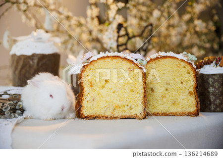 Sliced Easter bread with white bunny on festive spring table 136214689