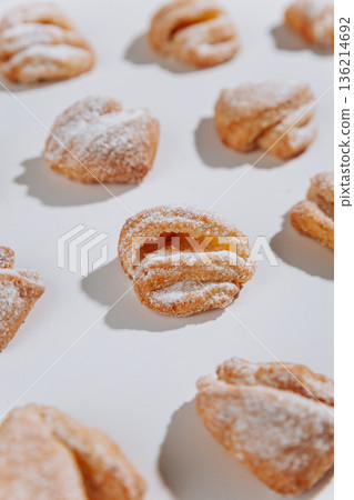Powdered sugar pastries close-up on white background, soft shadows Powdered sugar pastries close-up on white background, soft shadows 136214692