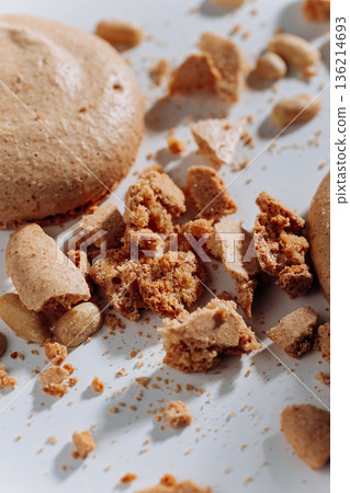 Peanut macaron crumbs and broken cookie pieces on white background, hard light Peanut macaron crumbs and broken cookie pieces on white background, hard light 136214693
